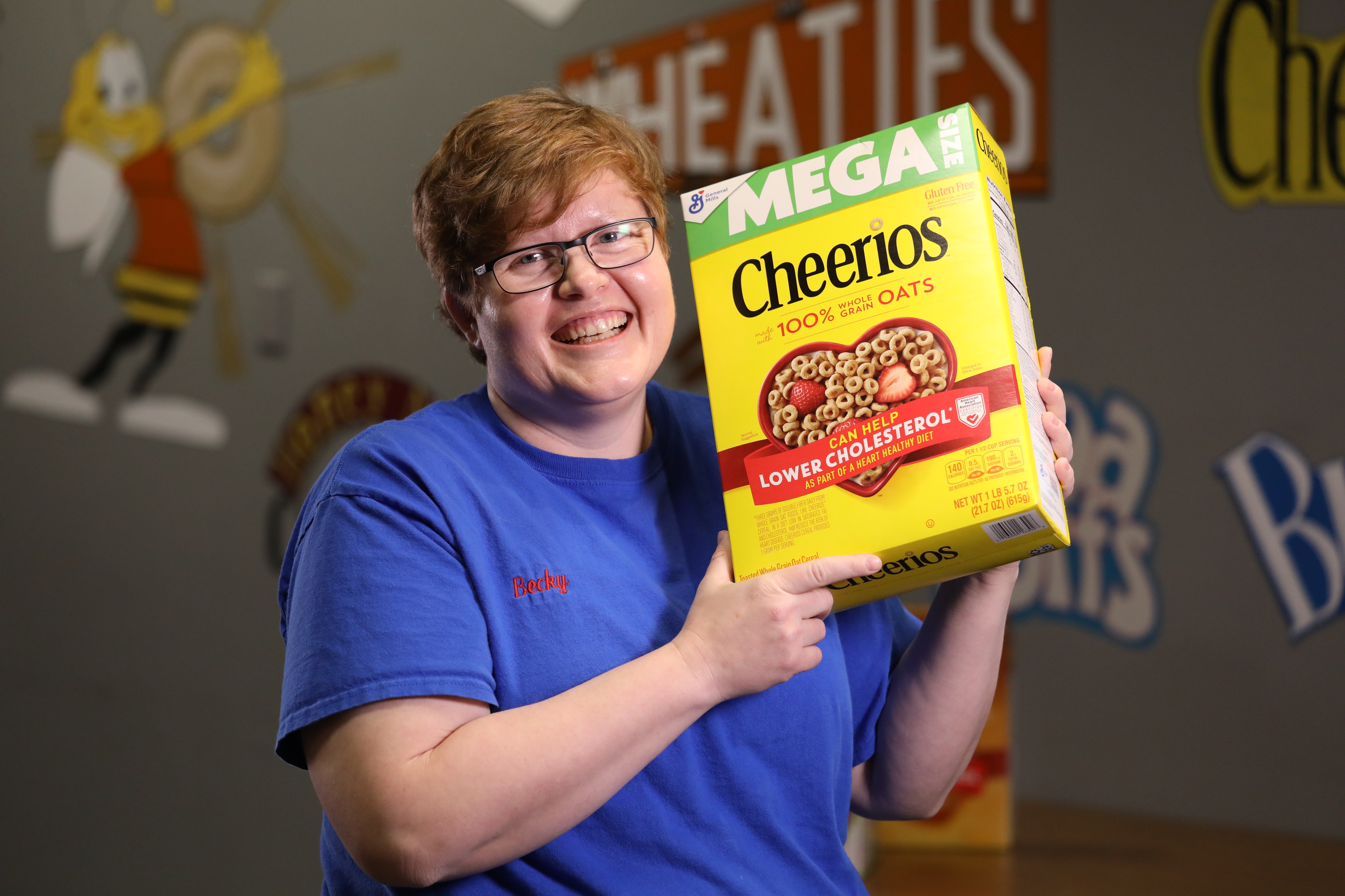 plant employee holding a box of Cheerios