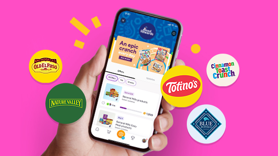Person holding a phone with several General Mills brand logos displayed on a pink background.