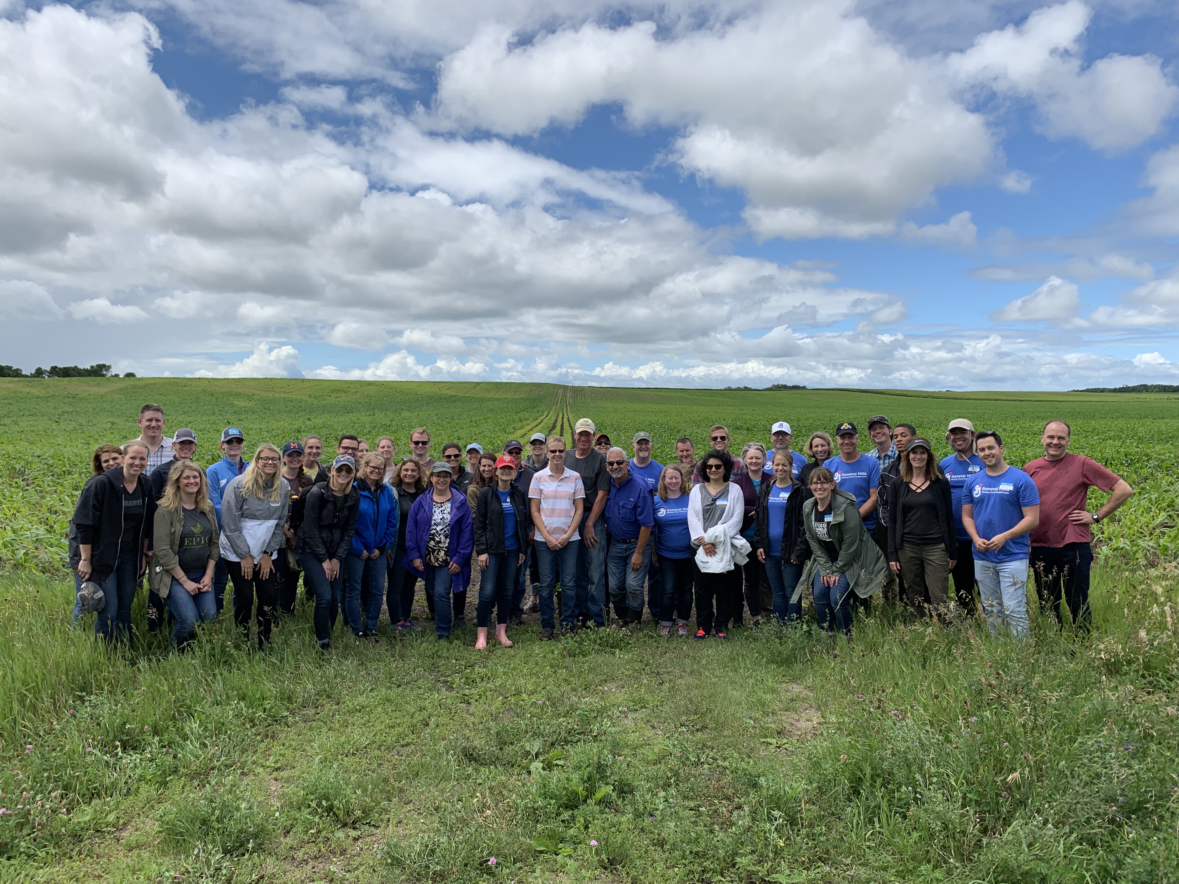 group photo of employees in field