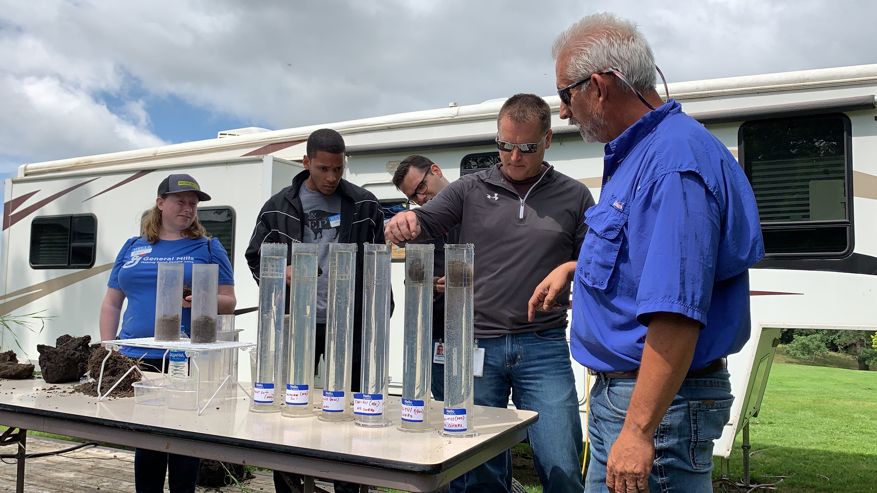 employees participating in soil demo