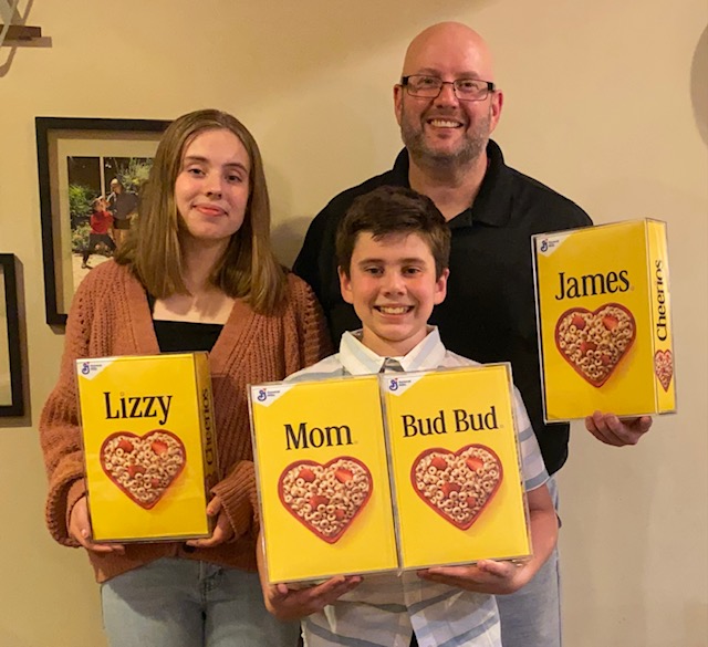 Beavers family holding Cheerios boxes