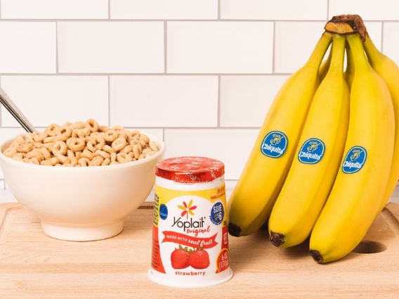 Cheerios, Yoplait yogurt and Chiquita bananas on a cutting board