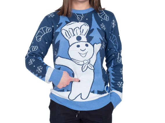 Woman wearing Pillsbury holiday sweater and pointing to the Doughboy's belly