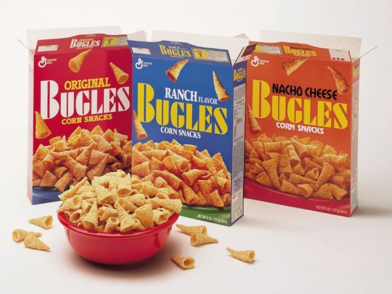 Image of opened boxes of original Bugles, Ranch Bugles, and Nacho Cheese Bugles on a white surface with a red bowl of overflowing bugles in front.