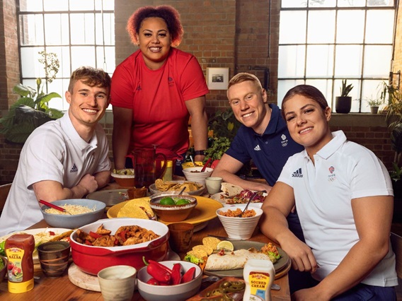 Team GB Olympic athletes, Bethany Shriever MBE, Emily Campbell, Jack Laugher MBE, and Tom Dean MBE, sitting around a dinner table enjoying an Old El Paso taco night meal together.