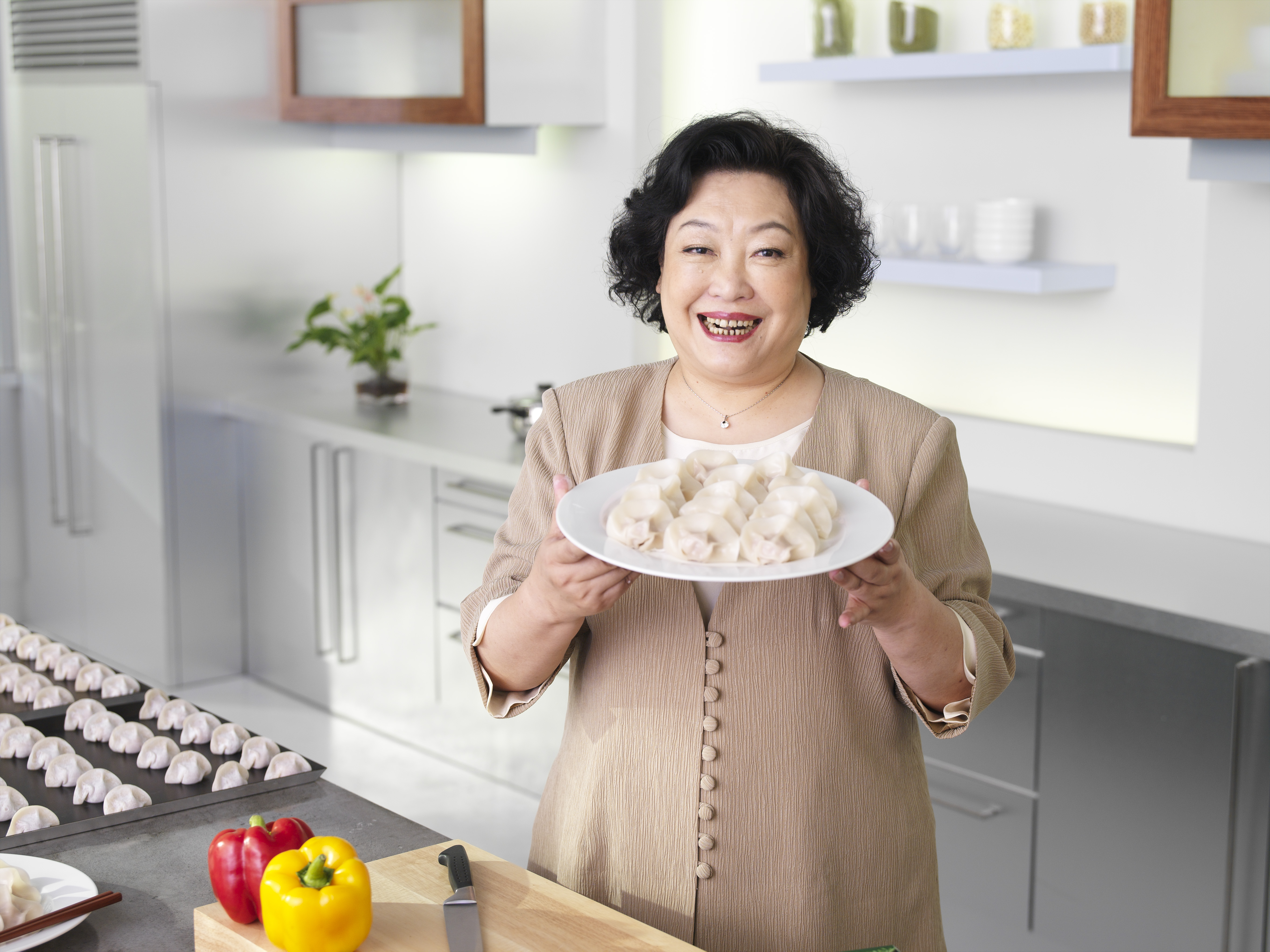 Zang Jianhe holding a plate of dumplings